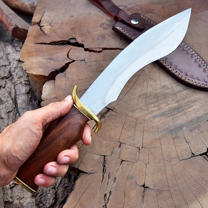 stainless steel hunting knife with rosewood handle held outdoors – SXH 1115