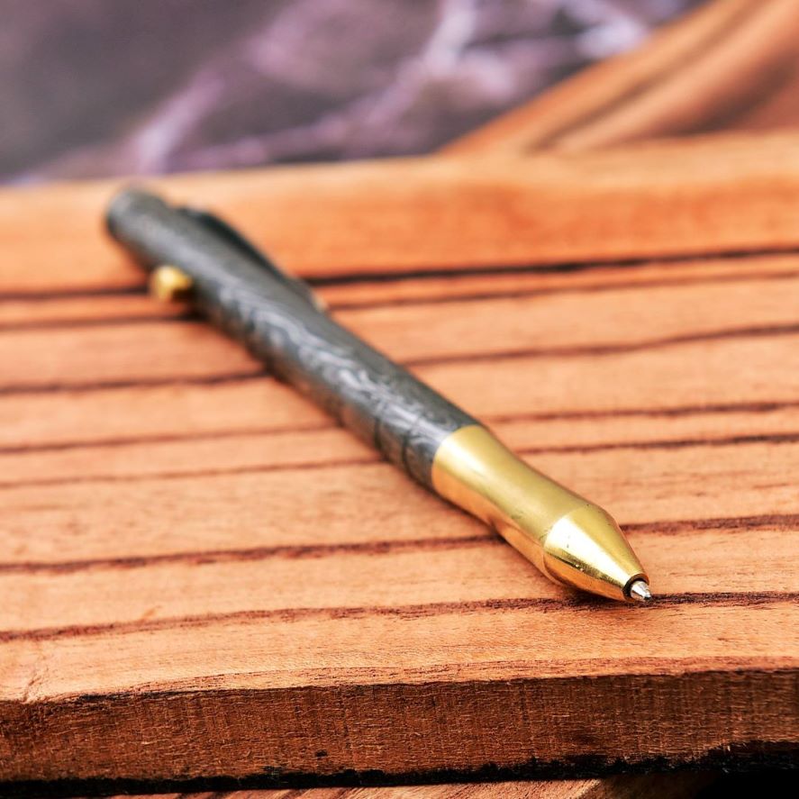 Tactile Excellence - Bolt Action Ballpoint Pen with Damascus Steel and Brass Craftsmanship.