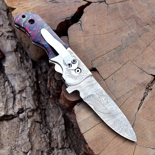 Hand-forged Damascus folding pocket knife with engraved steel bolster