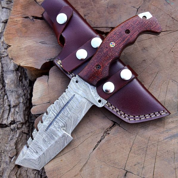 Damascus tracker hunting knife with brown Micarta handle and leather sheath on tree stump – DXH-1101