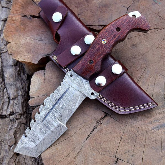 Damascus tracker hunting knife with brown Micarta handle and leather sheath on tree stump – DXH-1101