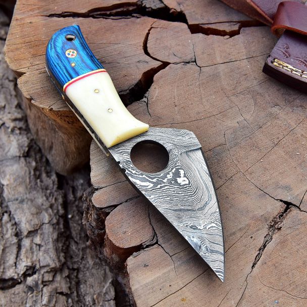 Angled shot of Damascus blade twist pattern with ergonomic Pakka wood and bone handle.