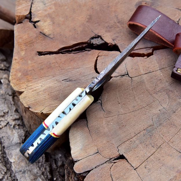 Top spine view of full-tang Damascus knife with handmade handle details.