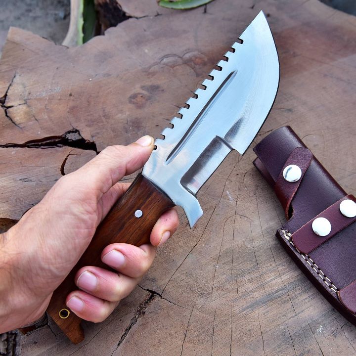 SXH1104 stainless steel knife on outdoor surface showing blade shine and overall premium build quality.